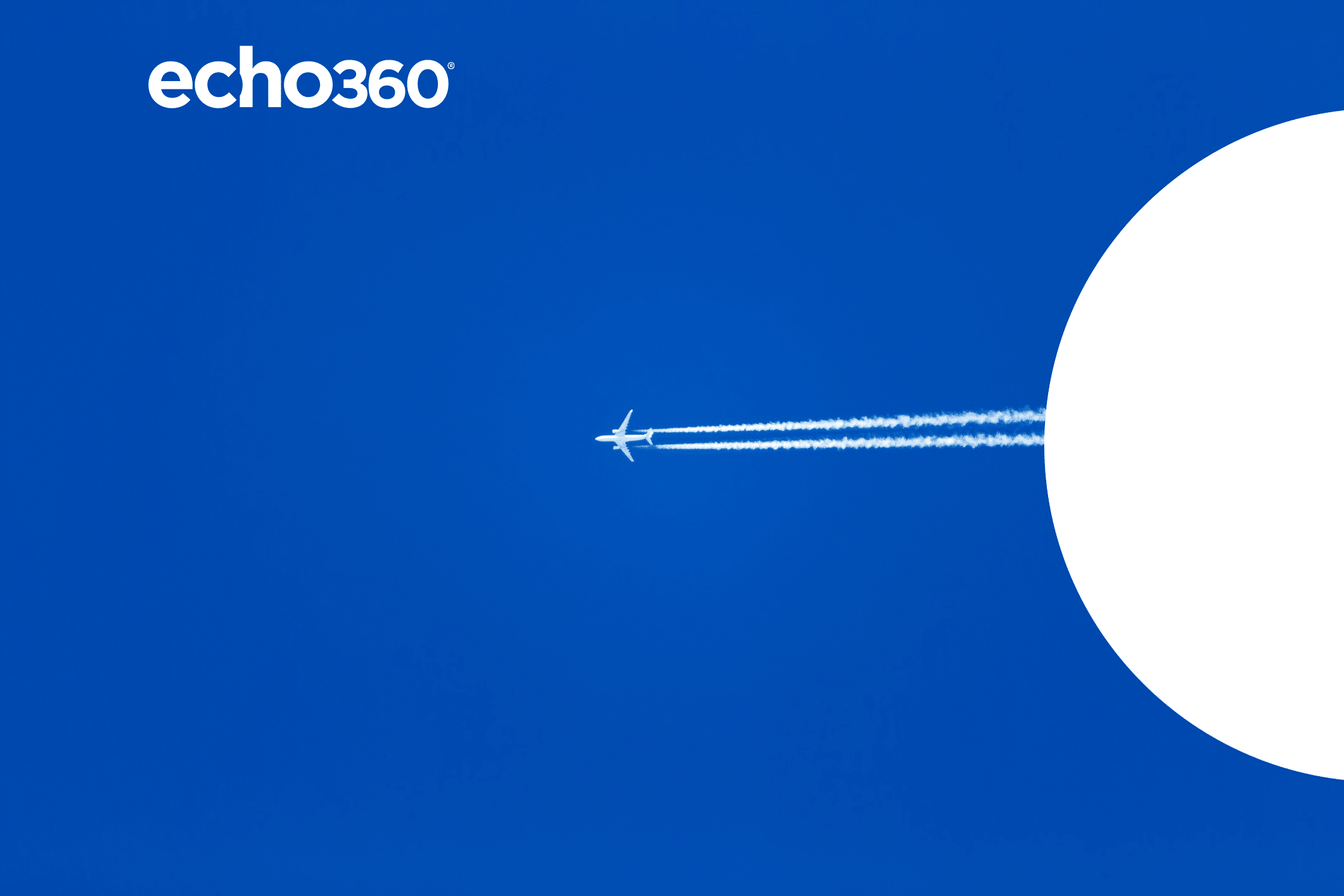 Commercial jet in the sky with two distinct contrails behind it.