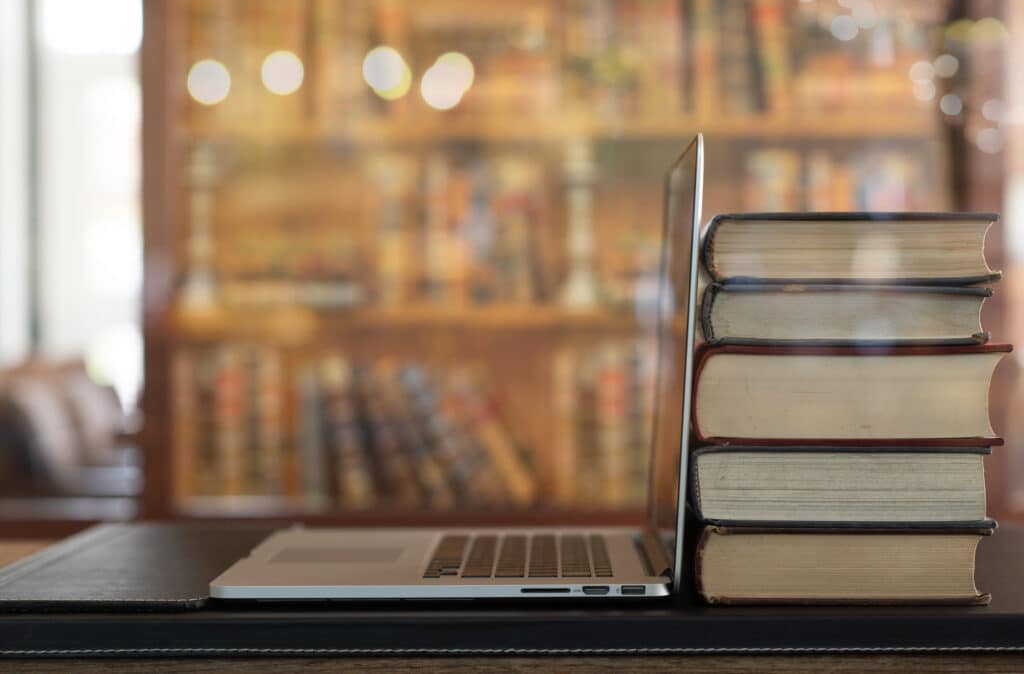 laptop and a stack of books