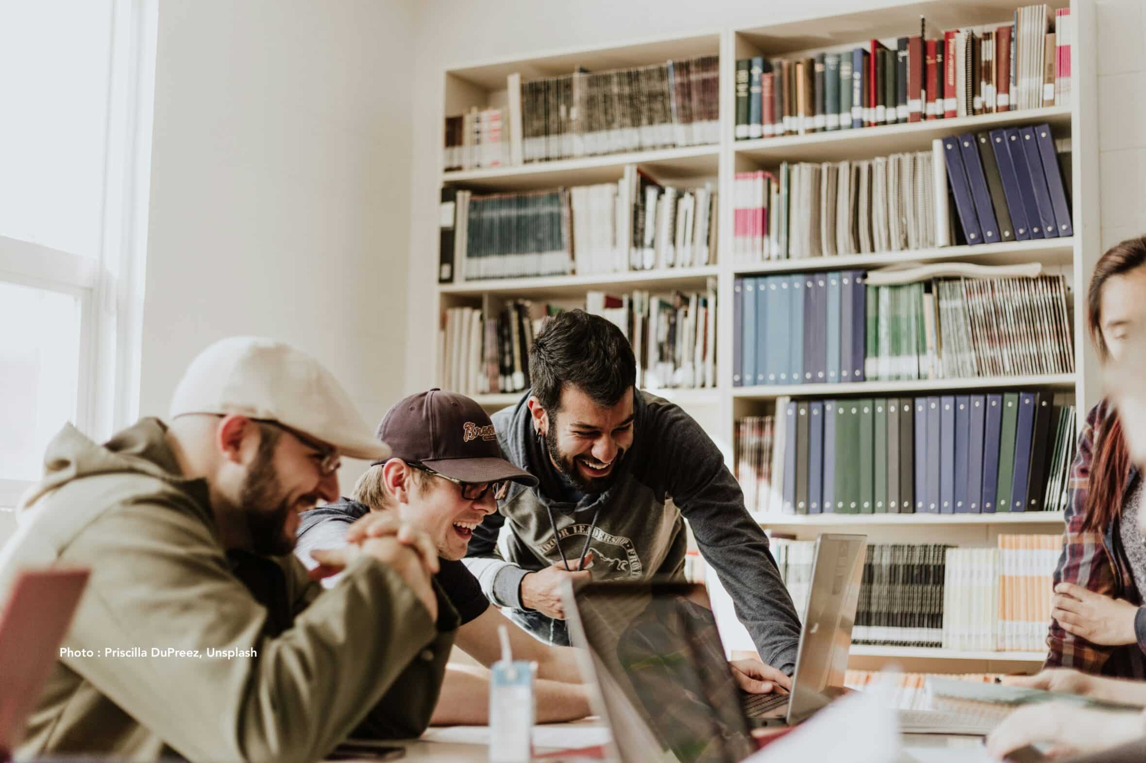 small group laughing looking at computer