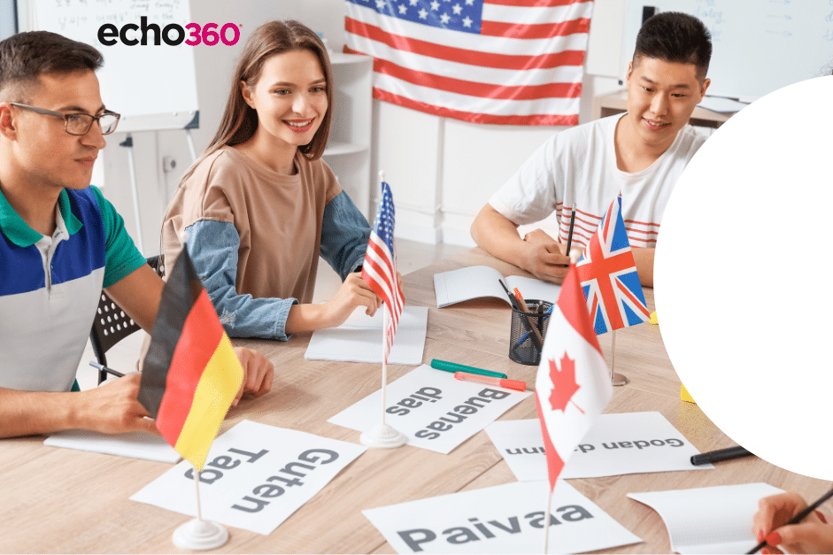 High school model United Nations meeting. Students with a teacher sitting around a table with different nation's flags and printed pages with words in different languages.