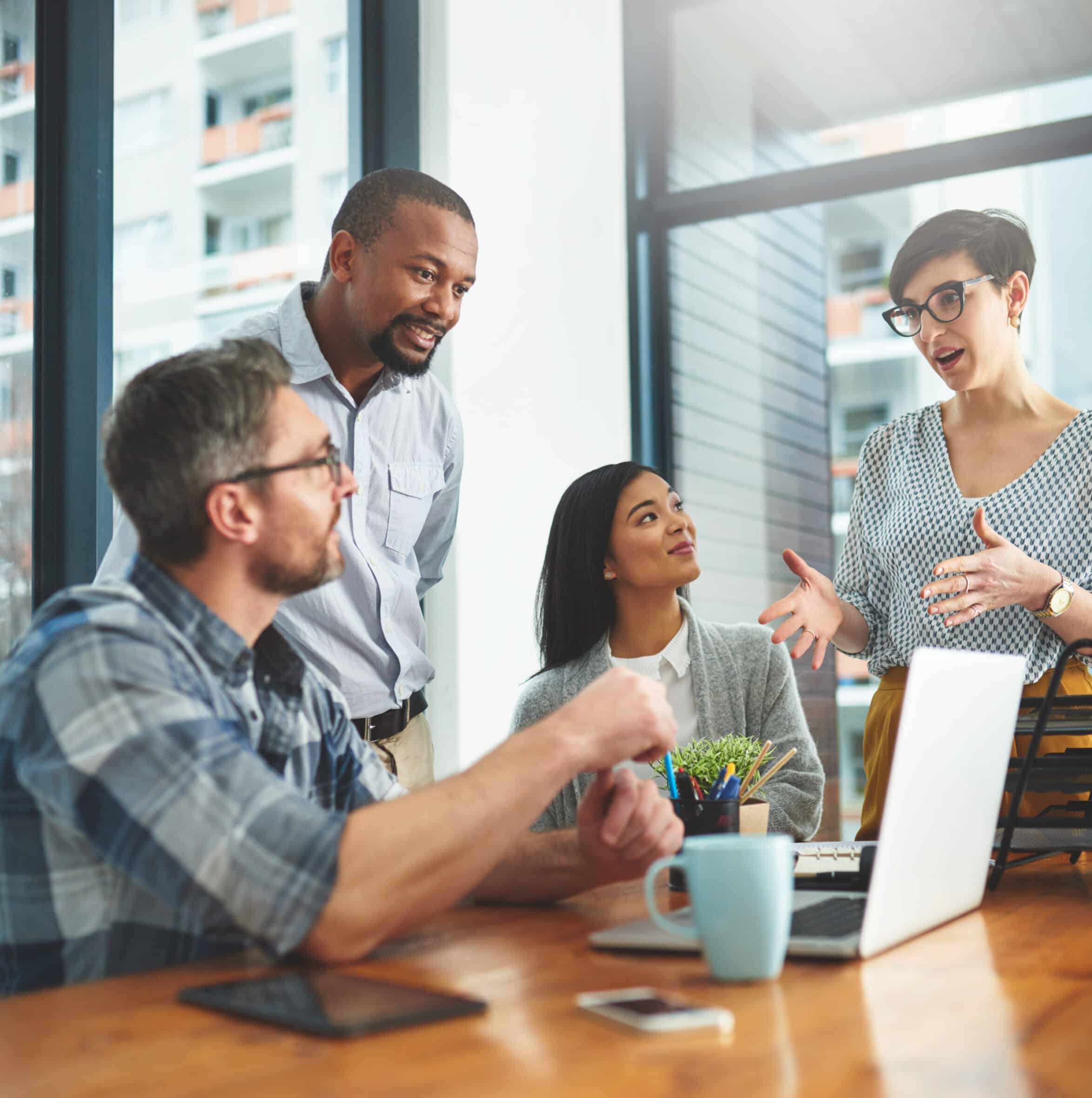 Teamwork, laptop and idea with business people in meeting for project management, review or planning. Technology, website and training with group of employees in office for collaboration and coaching