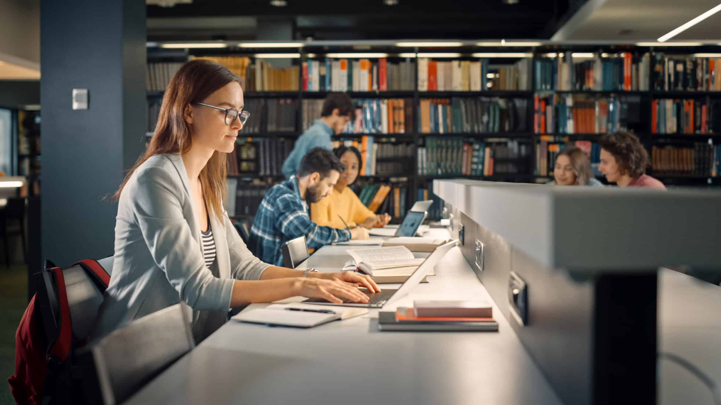 University Library: Talented Caucasian Girl Sitting at the Desk,