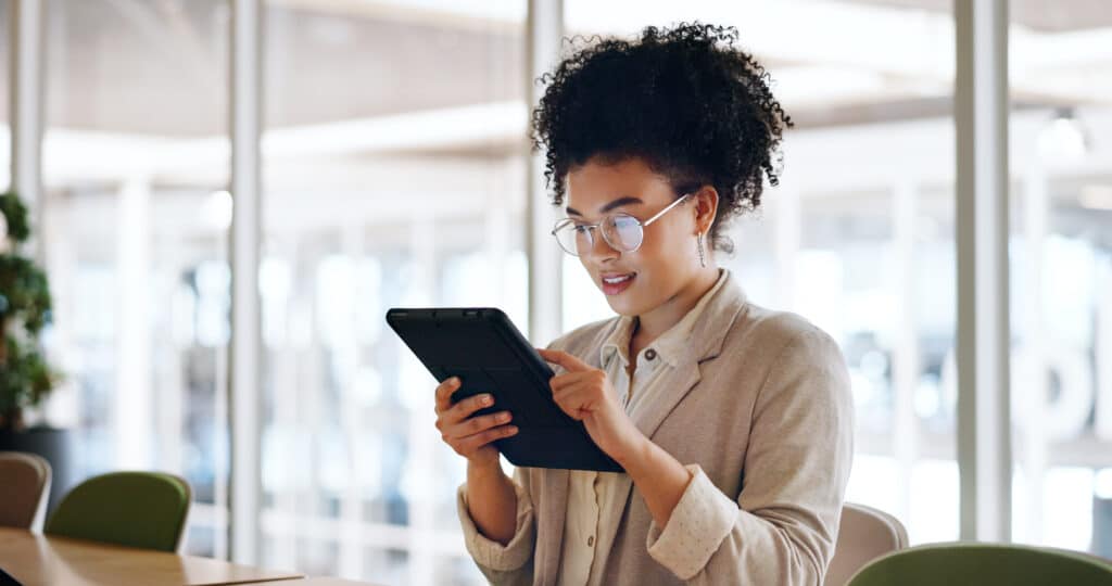 Tablet, black woman and business marketing, social media update or networking with smile. Website, company blog or online communication, office worker with glasses smile for digital strategy success.