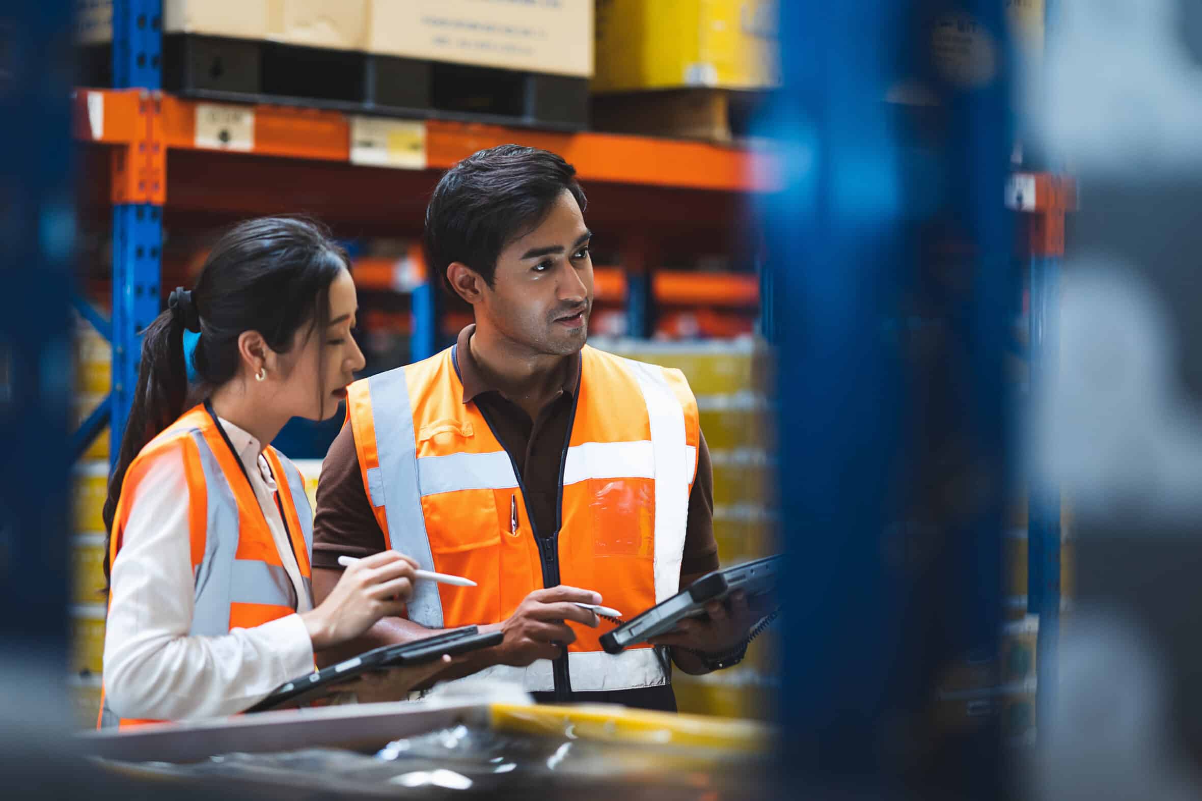 Warehouse worker and manager checks stock and inventory with usi